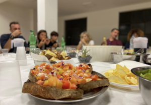 People sitting around a table with food.